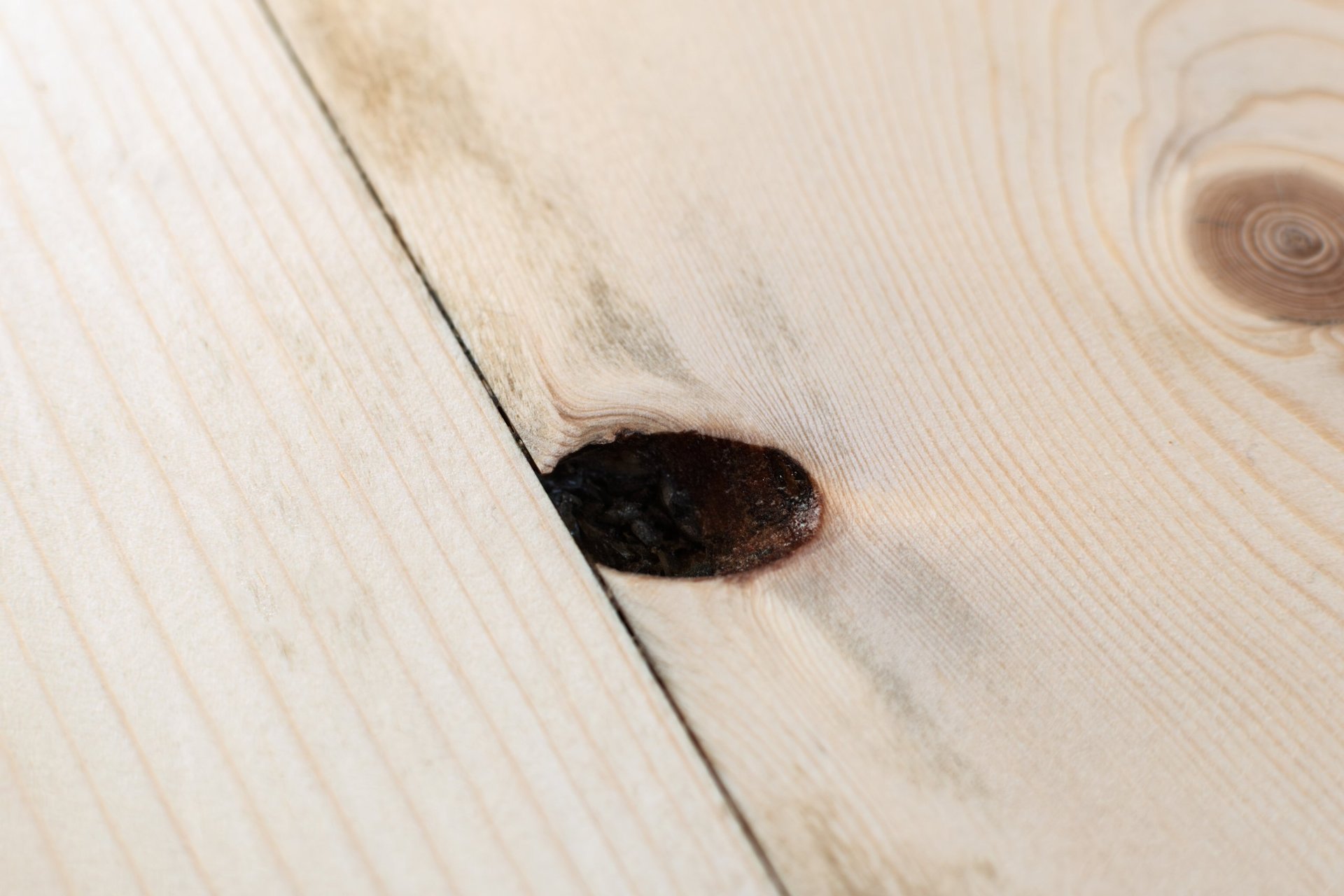 Wood floor with knot hole requiring repair