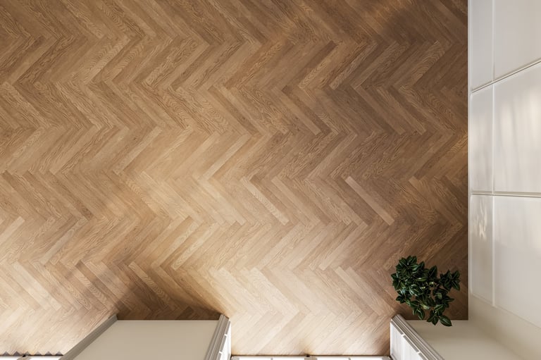 Top view of herringbone wooden floor with soft daylight and natural warm tones