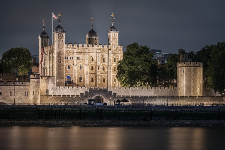 A night panoramic view of the illuminated Tower of London fortress walls and towers