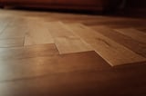 Close-up of laminate wood flooring with diagonal planks