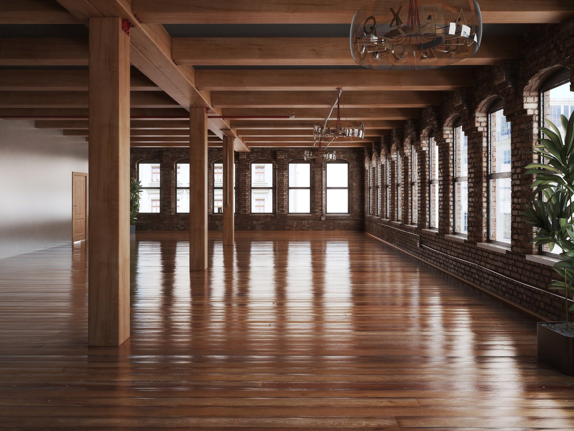 Spacious empty loft or warehouse interior with polished wooden floors, exposed wooden beams, large windows, and industrial lighting fixtures